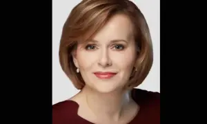 Portret Anny Krupki. Uśmiechnięta kobieta o krótkich, brązowych włosach i perłowych kolczykach. Jej życie prywatne budzi zainteresowanie.
